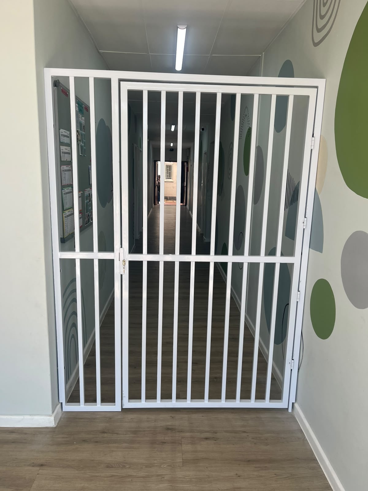 Custom white steel security gate by Button Creations