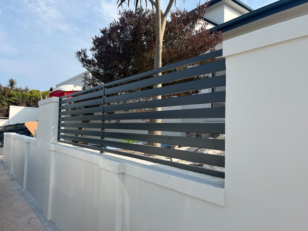 Dark grey horizontal steel fencing panel installed at a property in Bloubergstrand