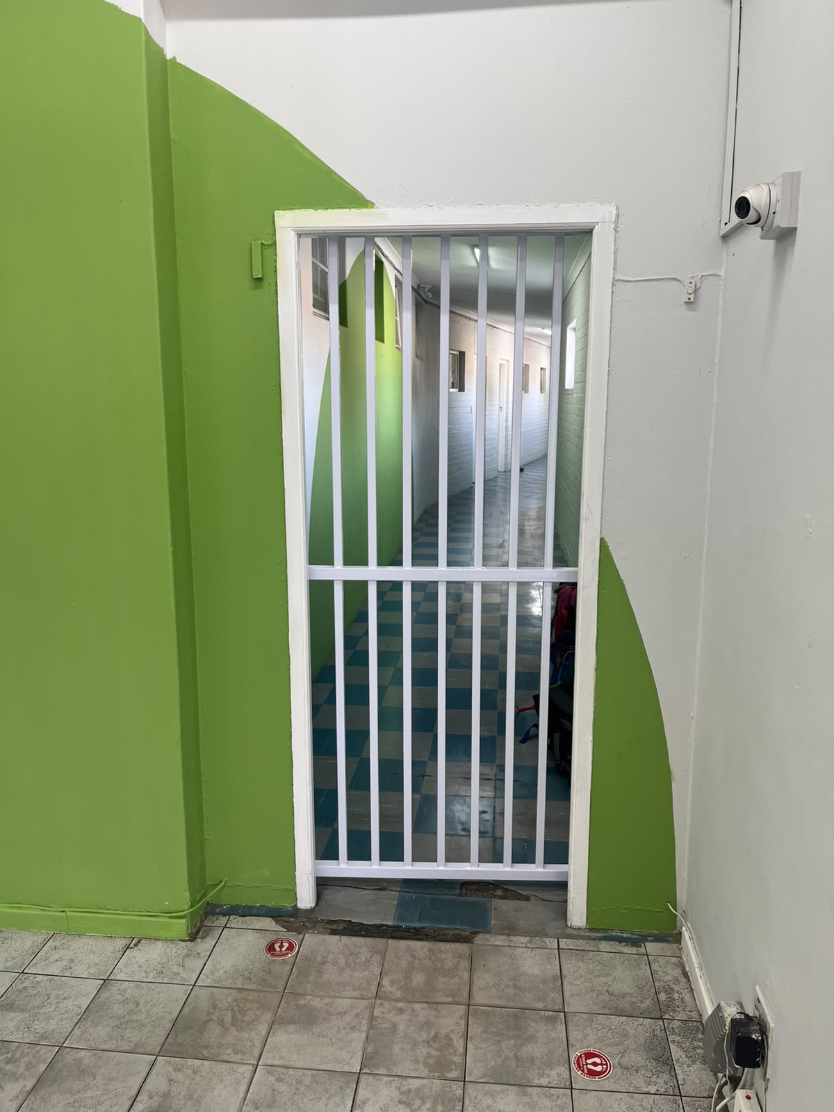 White vertical-bar steel security gate installed in Table View